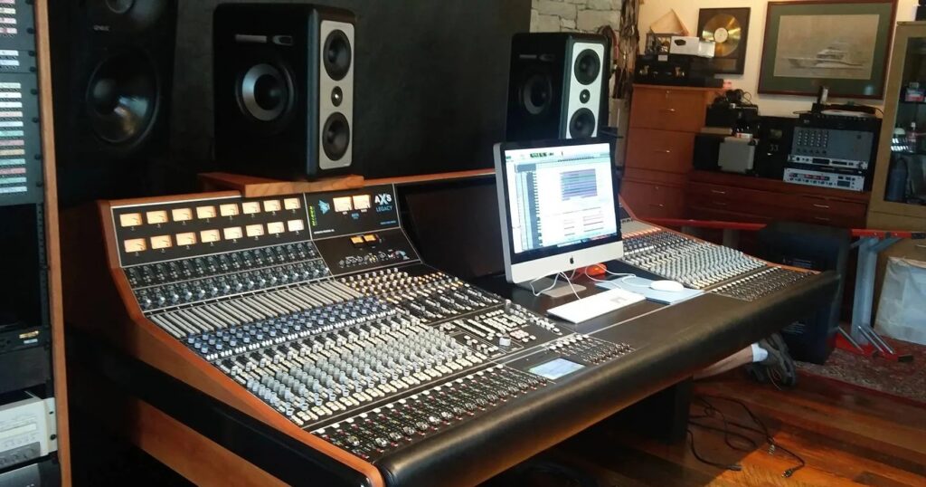 API Legacy AXS large-format analog mixing console in a pro recording studio control room