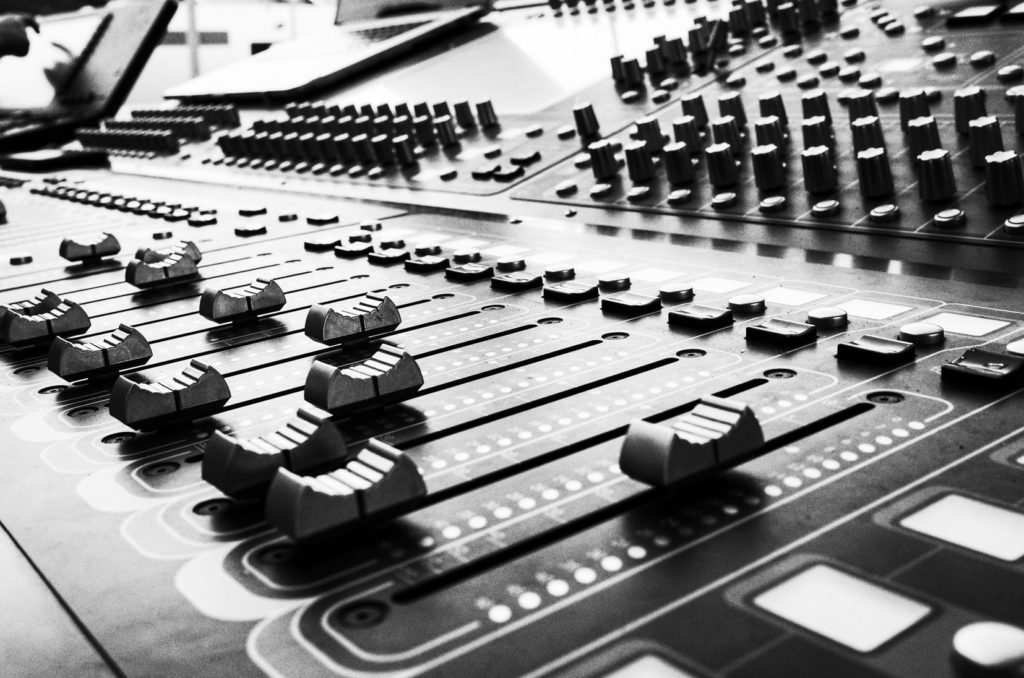 Pro mixing console showing channel strips and signal flow path from input to bus